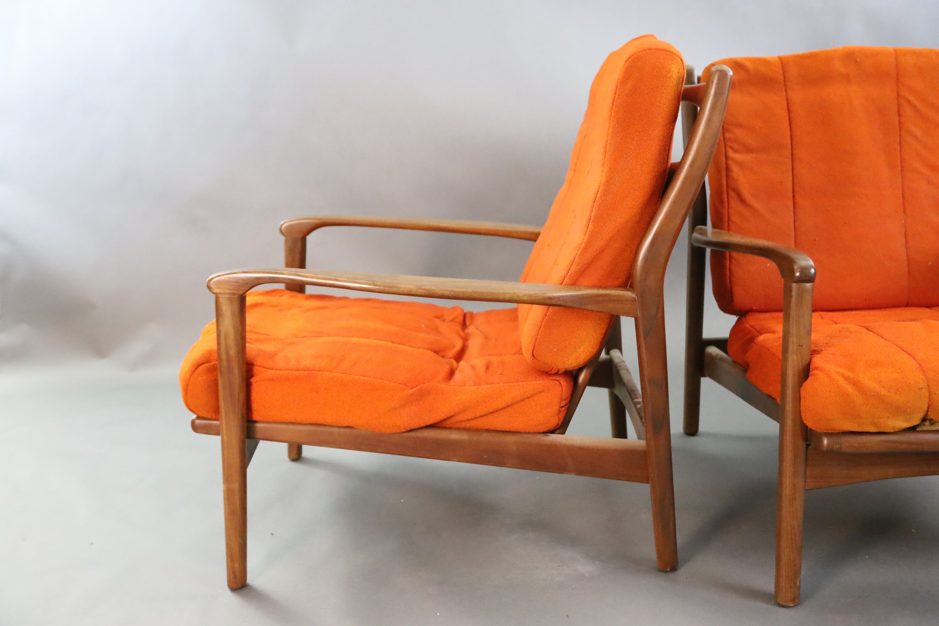 A pair of mid century Danish teak armchairs, W.2ft 2.5in. D.2ft 10in. H.2ft 8in.